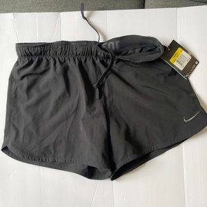 NIKE RUNNING SHORTS WITH BUILT IN SPANDEX.